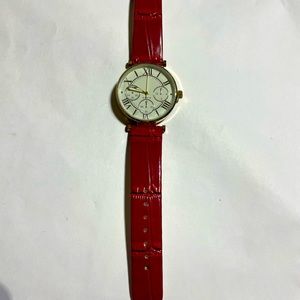 Red Fashion watch, never worn, still has plastic on the face. Cute watch.
